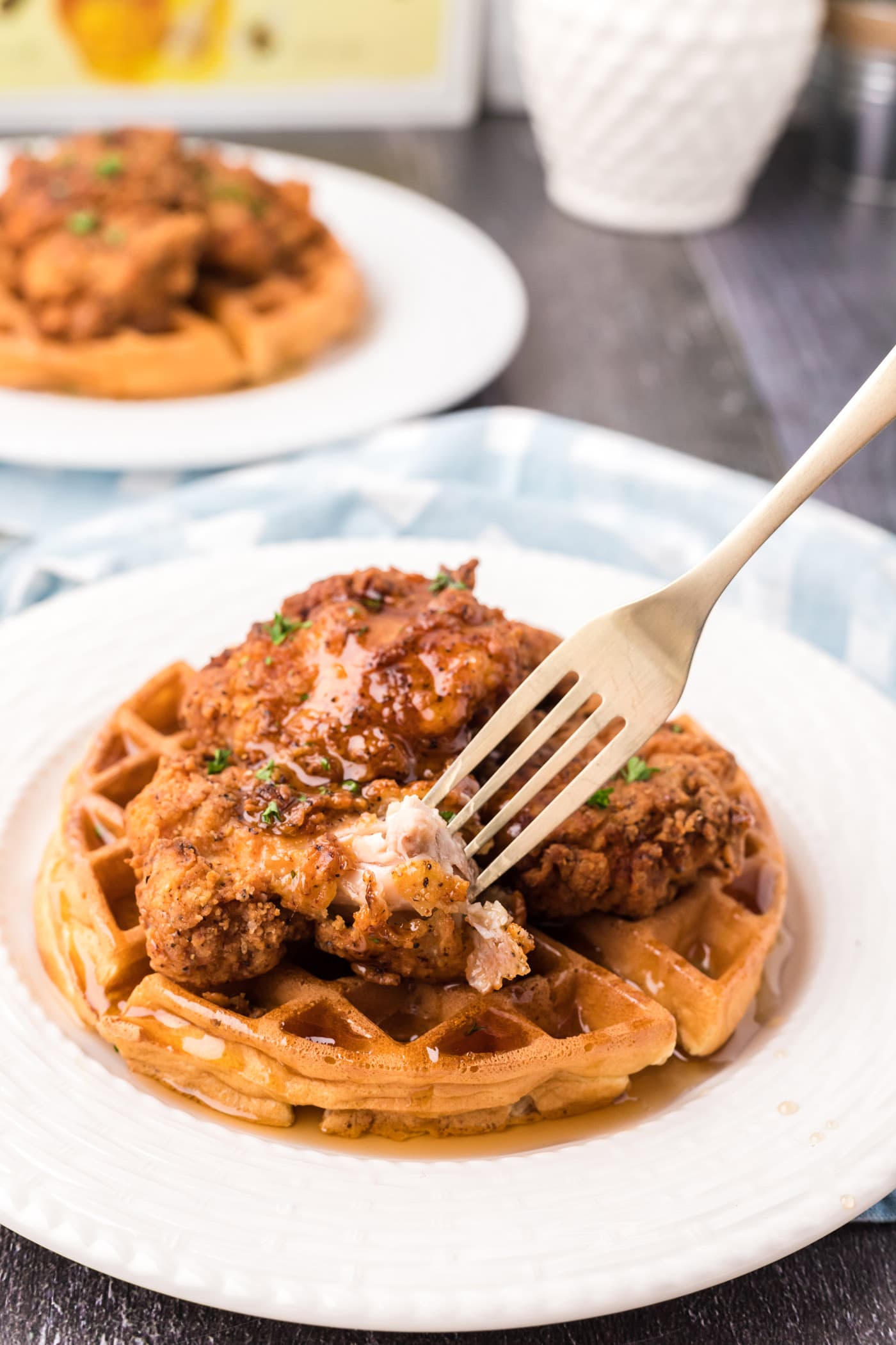 Fork taking a piece of Chicken and Waffles