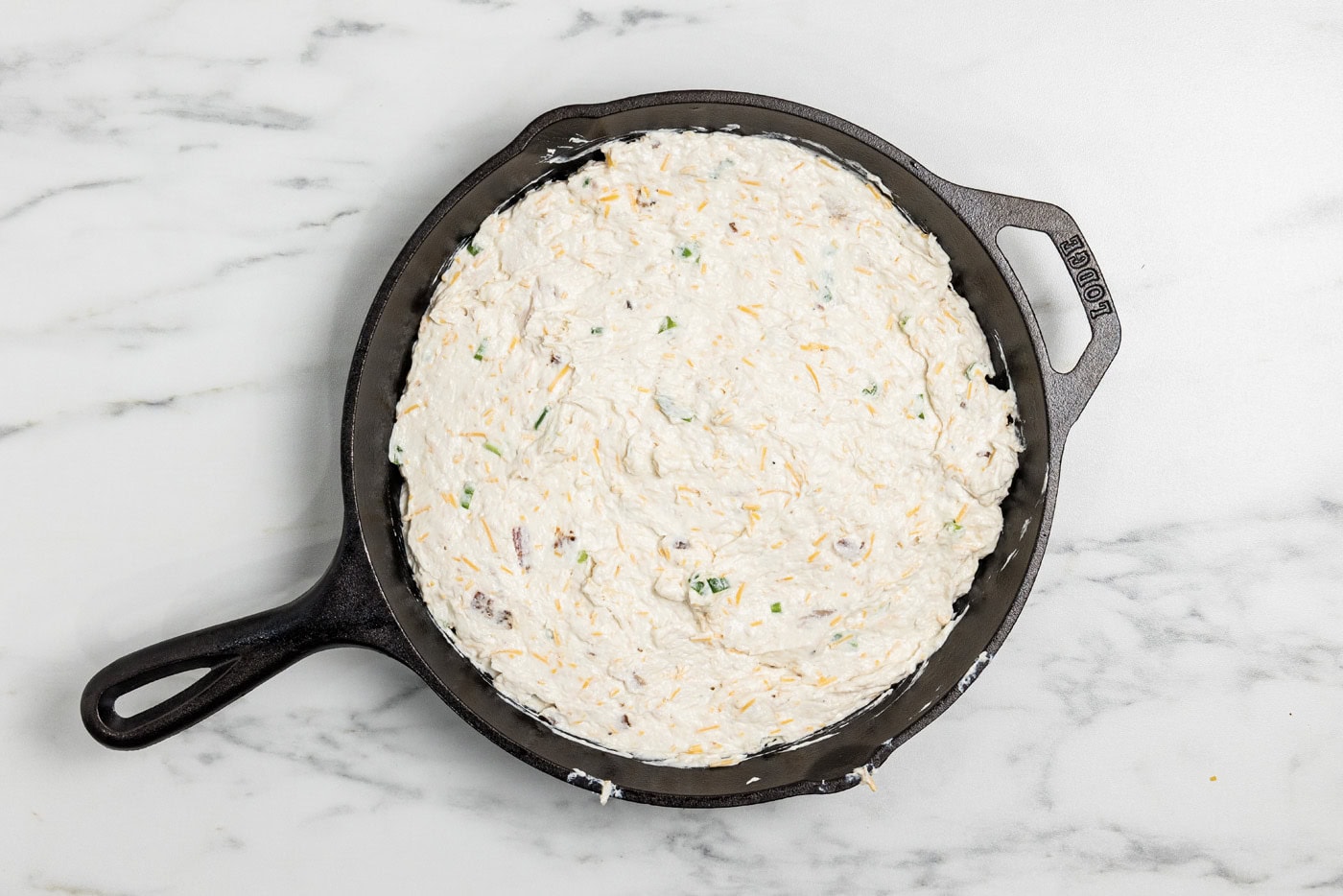 chicken bacon ranch dip mixture in a cast iron skillet