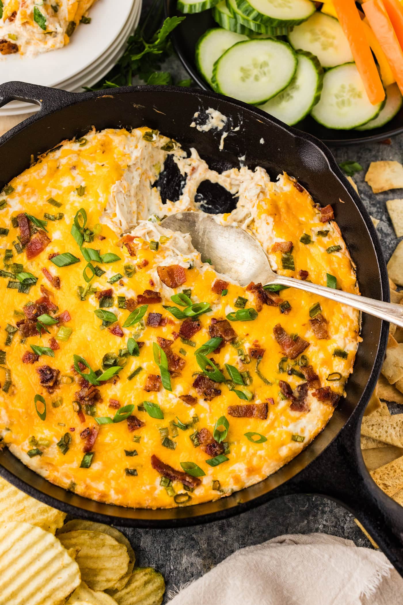 Spoon in a skillet of Chicken Bacon Ranch Dip