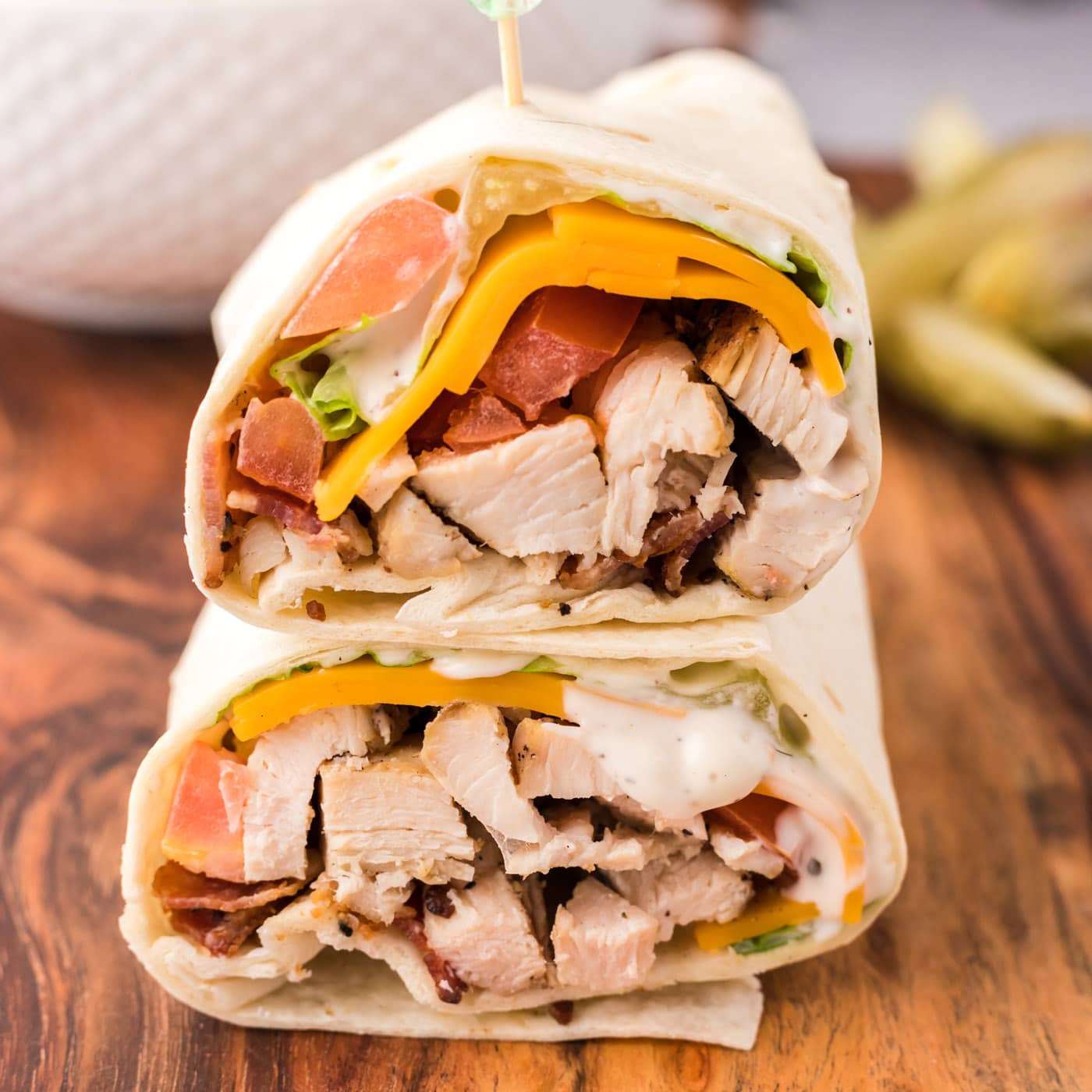 Close up photo of a Chicken Bacon Ranch Wrap cut in half and stacked on top of eachother