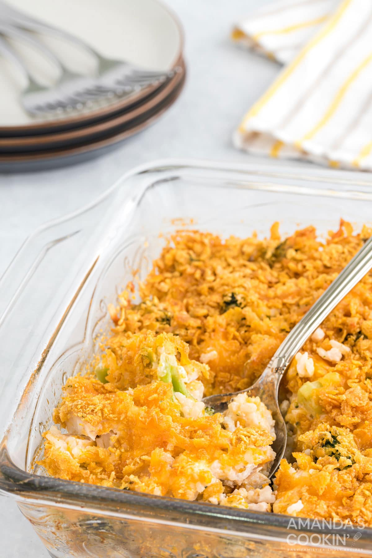 glass dish of Make Chicken Broccoli Rice Casserole with a spoon