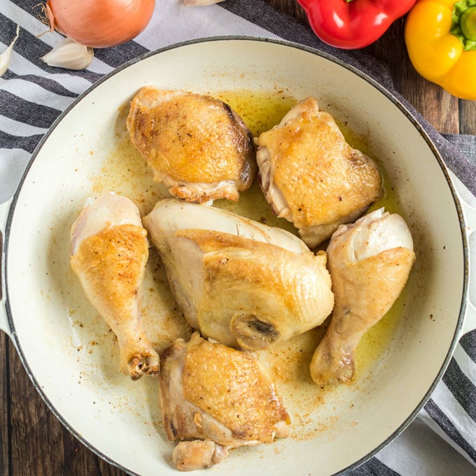 browned chicken pieces in a pan