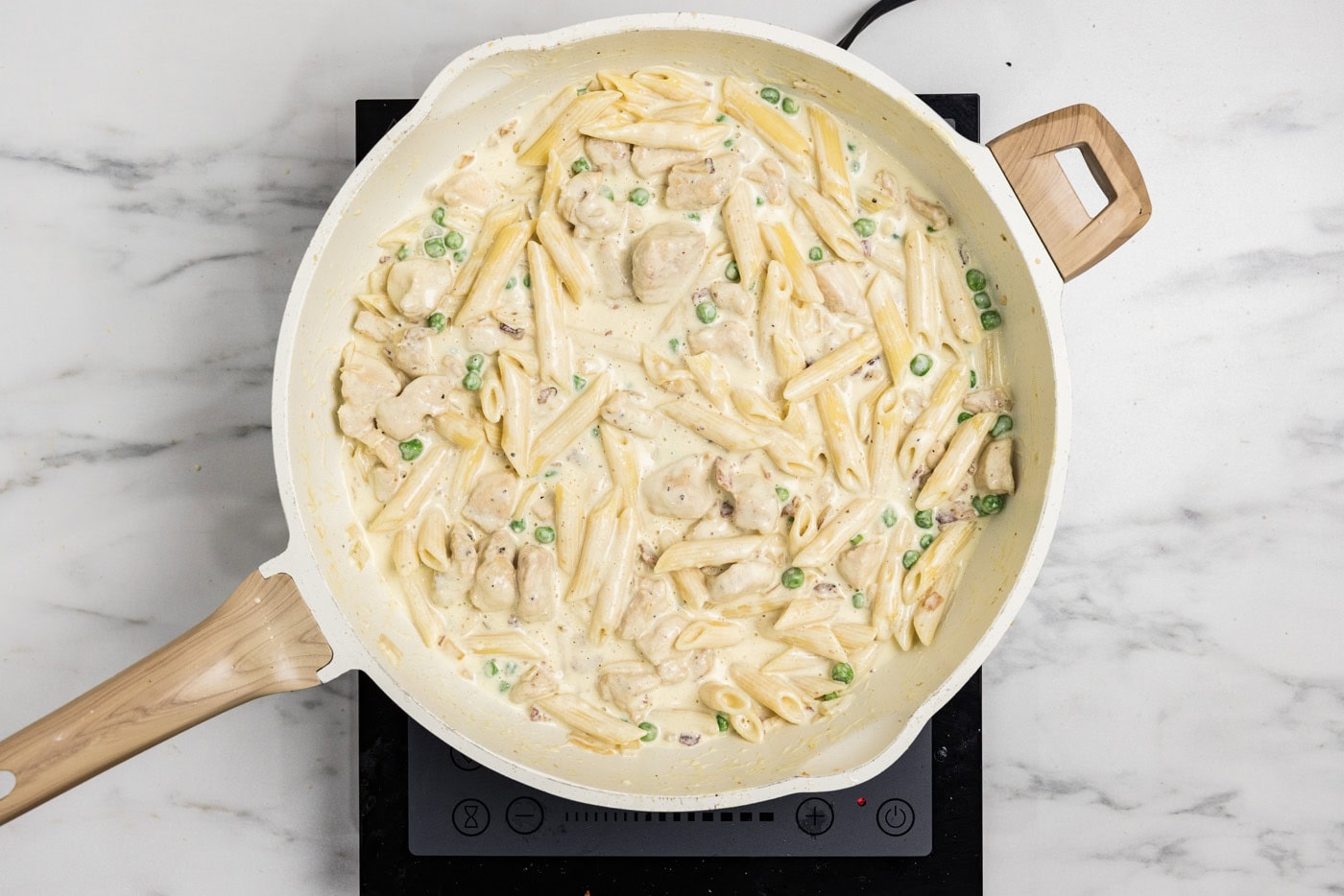 overhead photo of finished chicken carbonara in a skillet