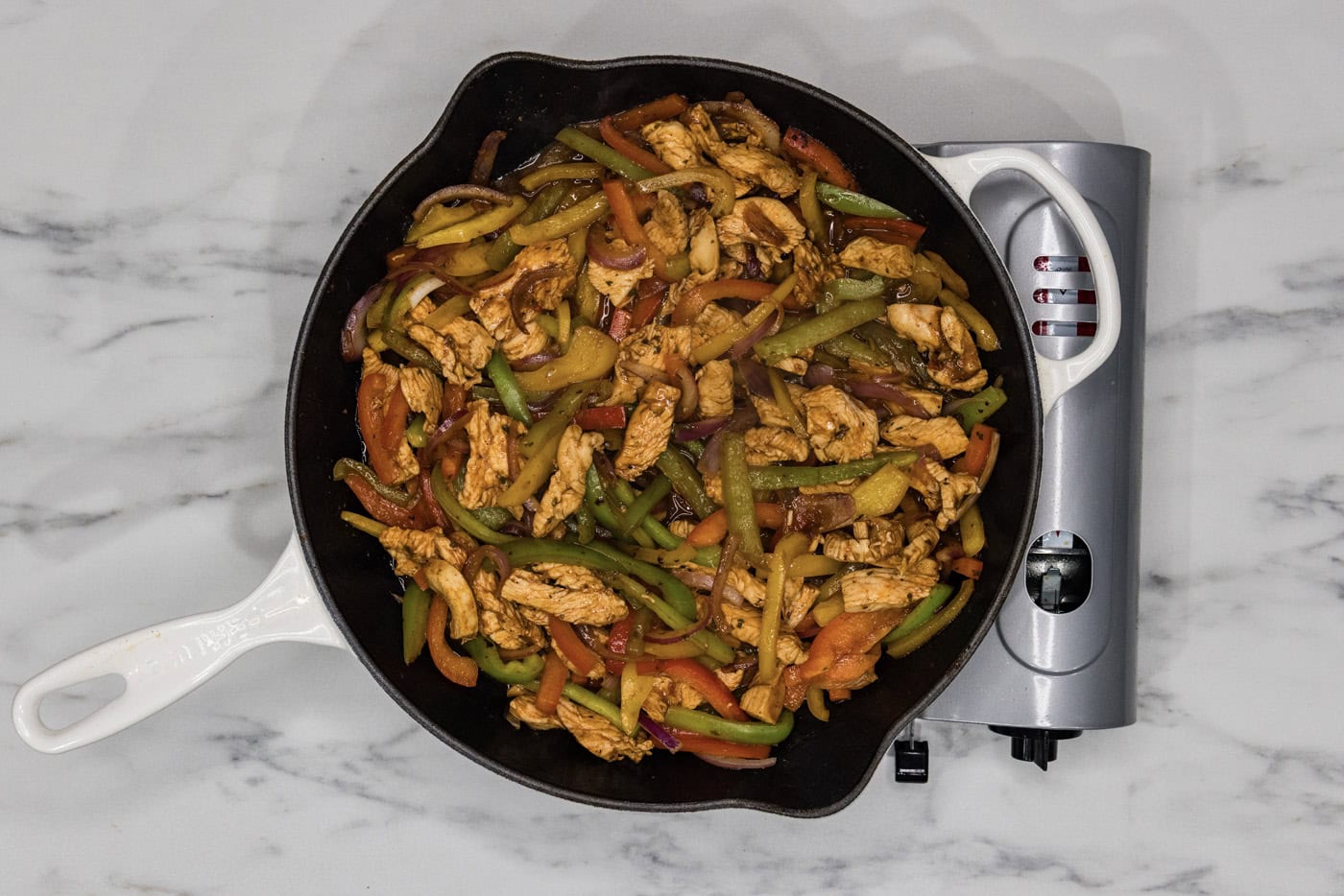 chicken fajitas in a cast iron skillet