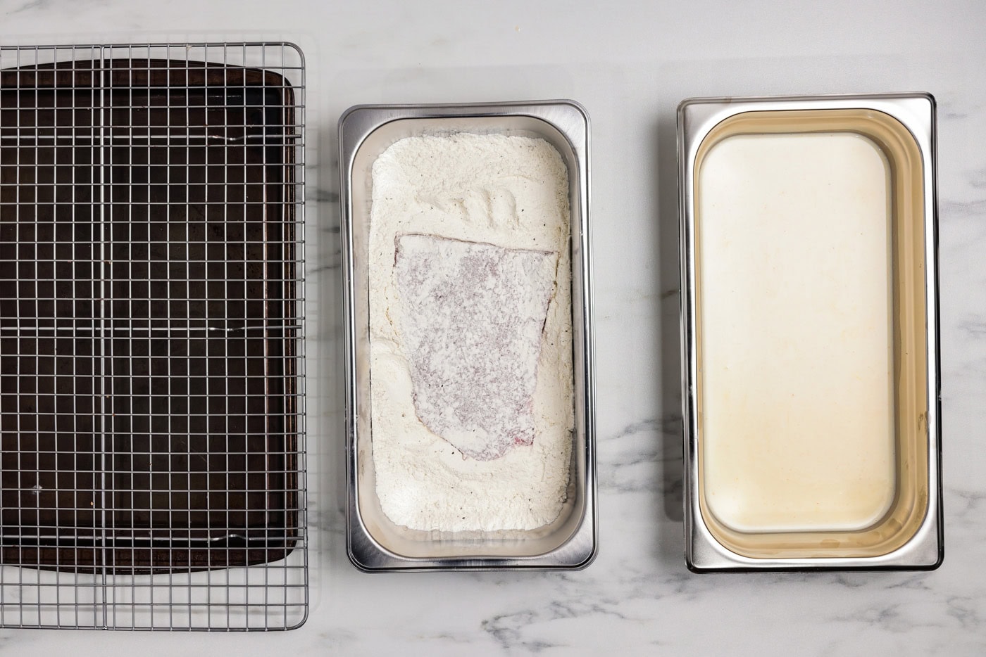 cube steak in a breading tray with flour mixture