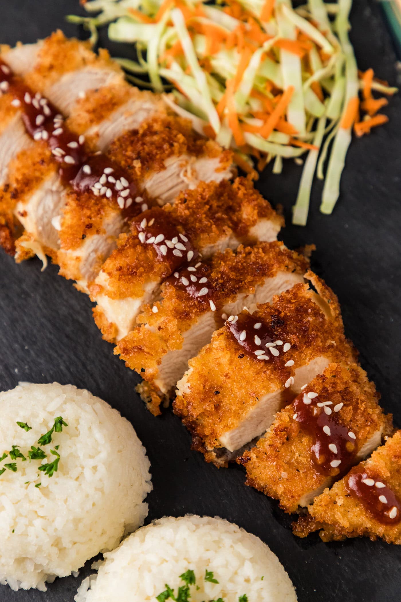Close up photo of Chicken Katsu cut into slices on a platter