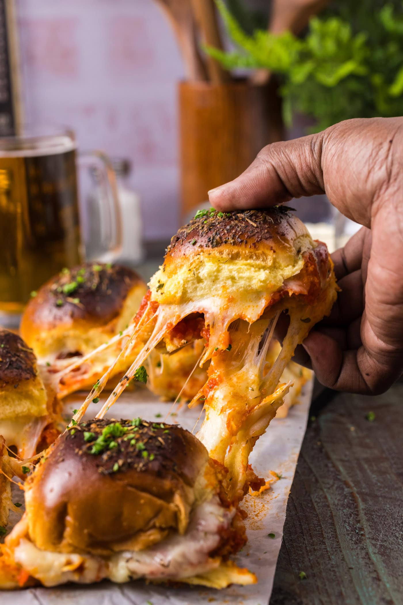 Hand pulling up a Chicken Parmesan Slider