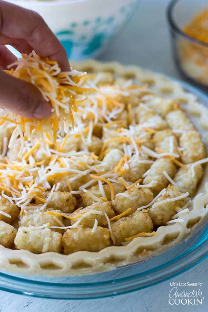 sprinkling cheese on tater tot casserole
