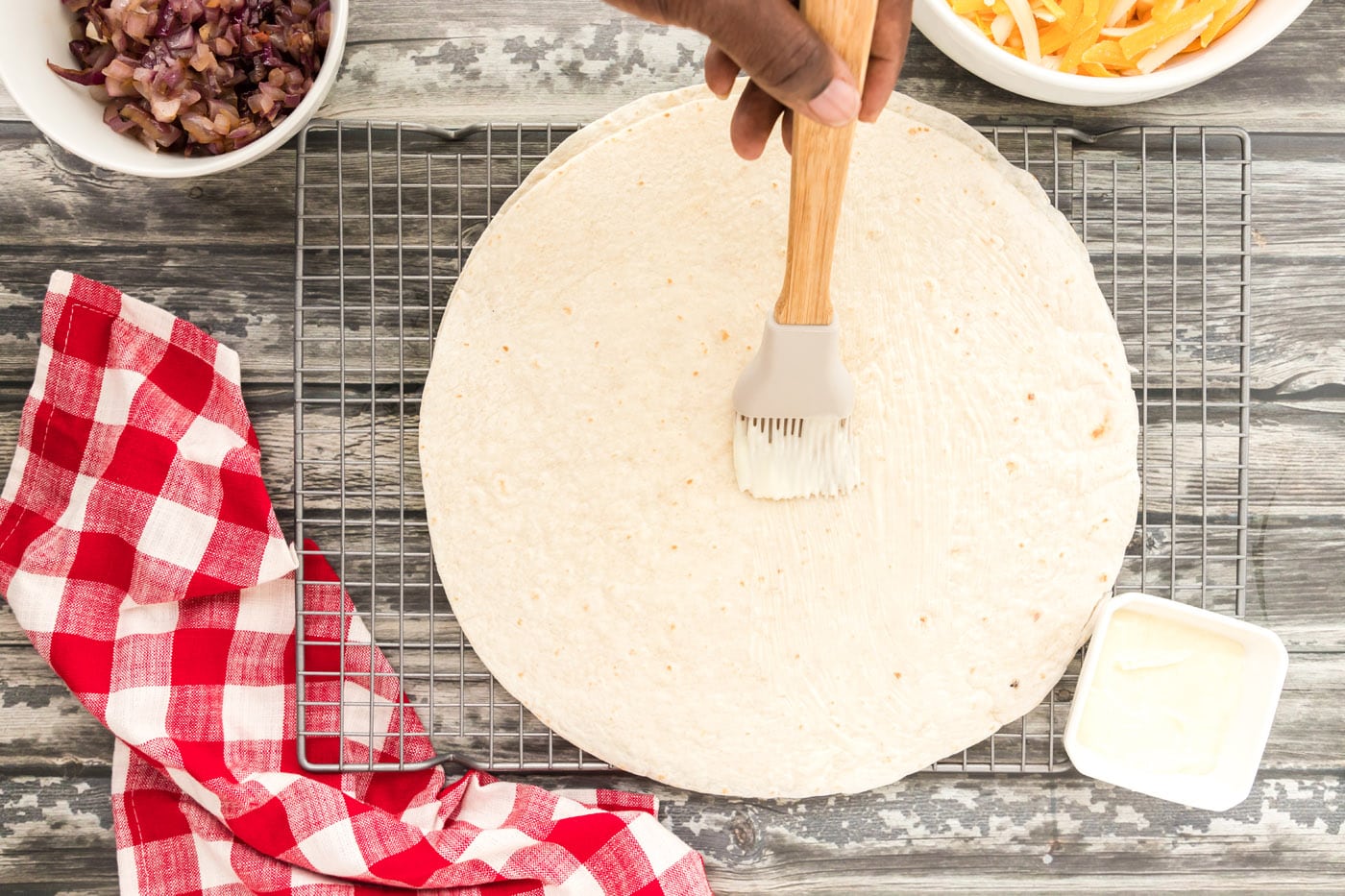 buttering a tortilla