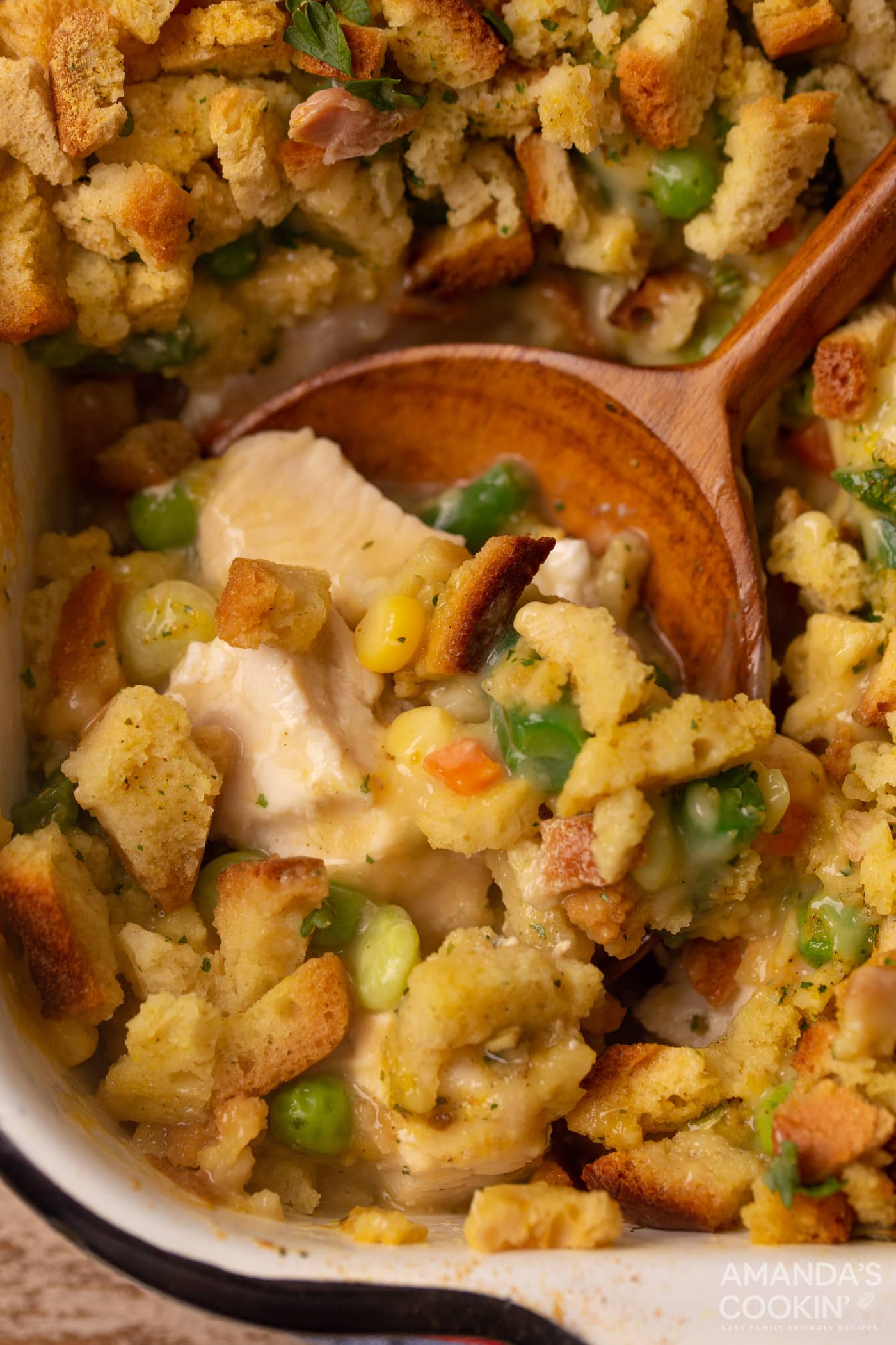 wooden spoon in dish of Chicken Stuffing Casserole