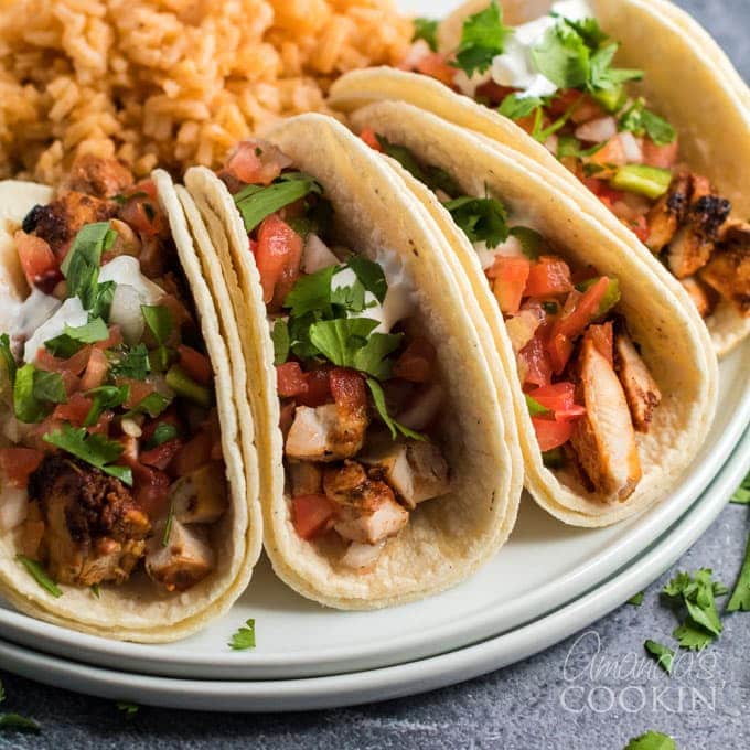 plate with 4 chicken tacos in corn tortilla shells