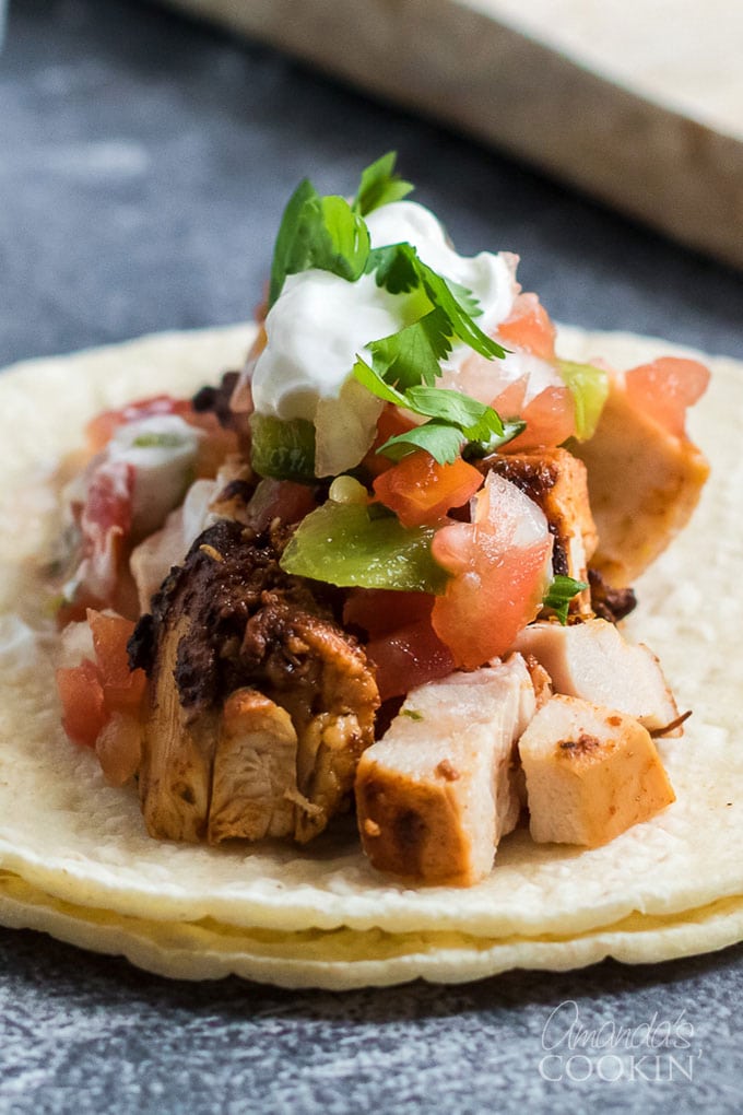 close up on chicken taco ingredients on corn tortilla