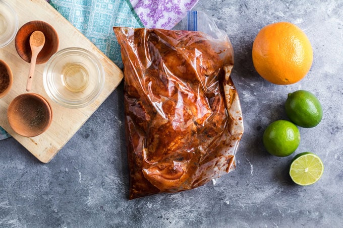 chicken marinating in a plastic bag
