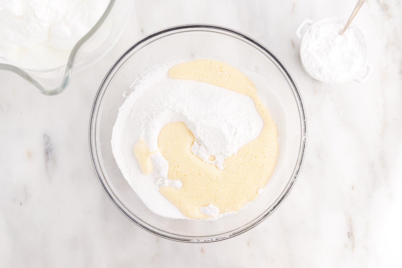 egg yolk mixture added to flour mixture in a bowl