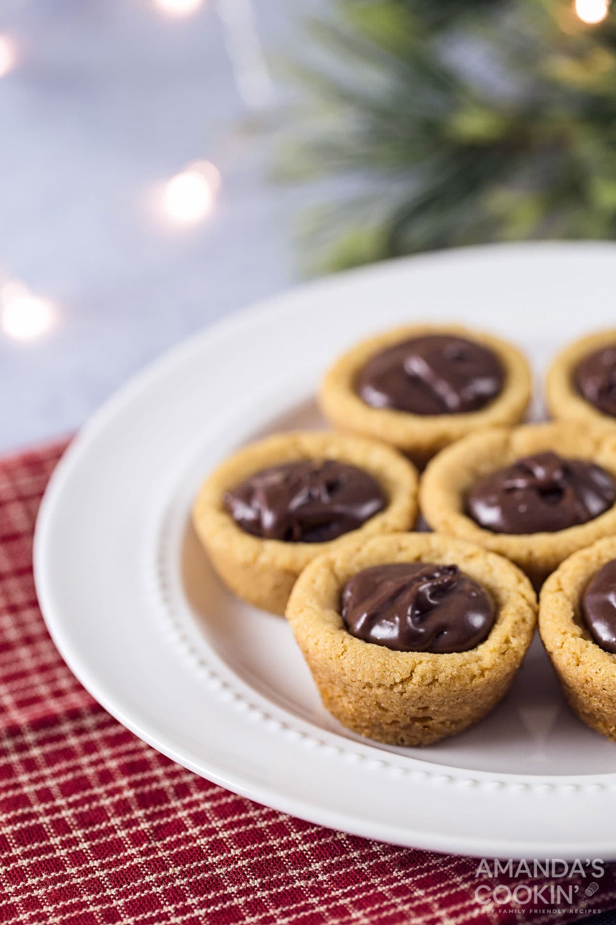 plate of cookie cups filled with chocolate (fudge puddles)