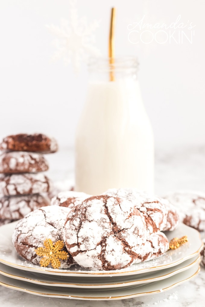 chocolate crinkle cookies on plate with bottle of milk