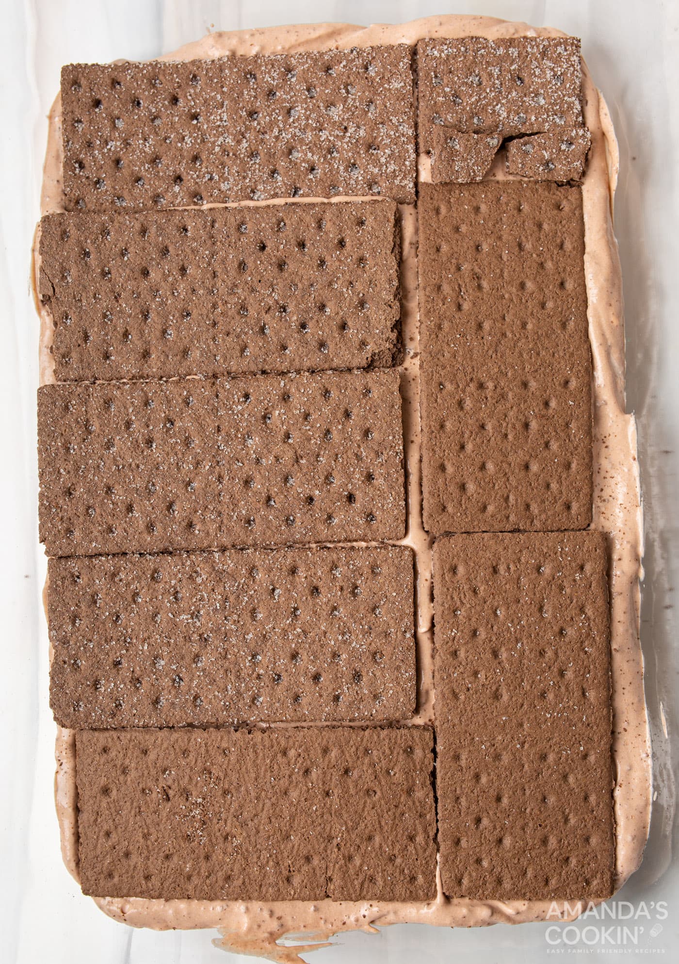 graham crackers on top of chocolate pudding mix in baking dish
