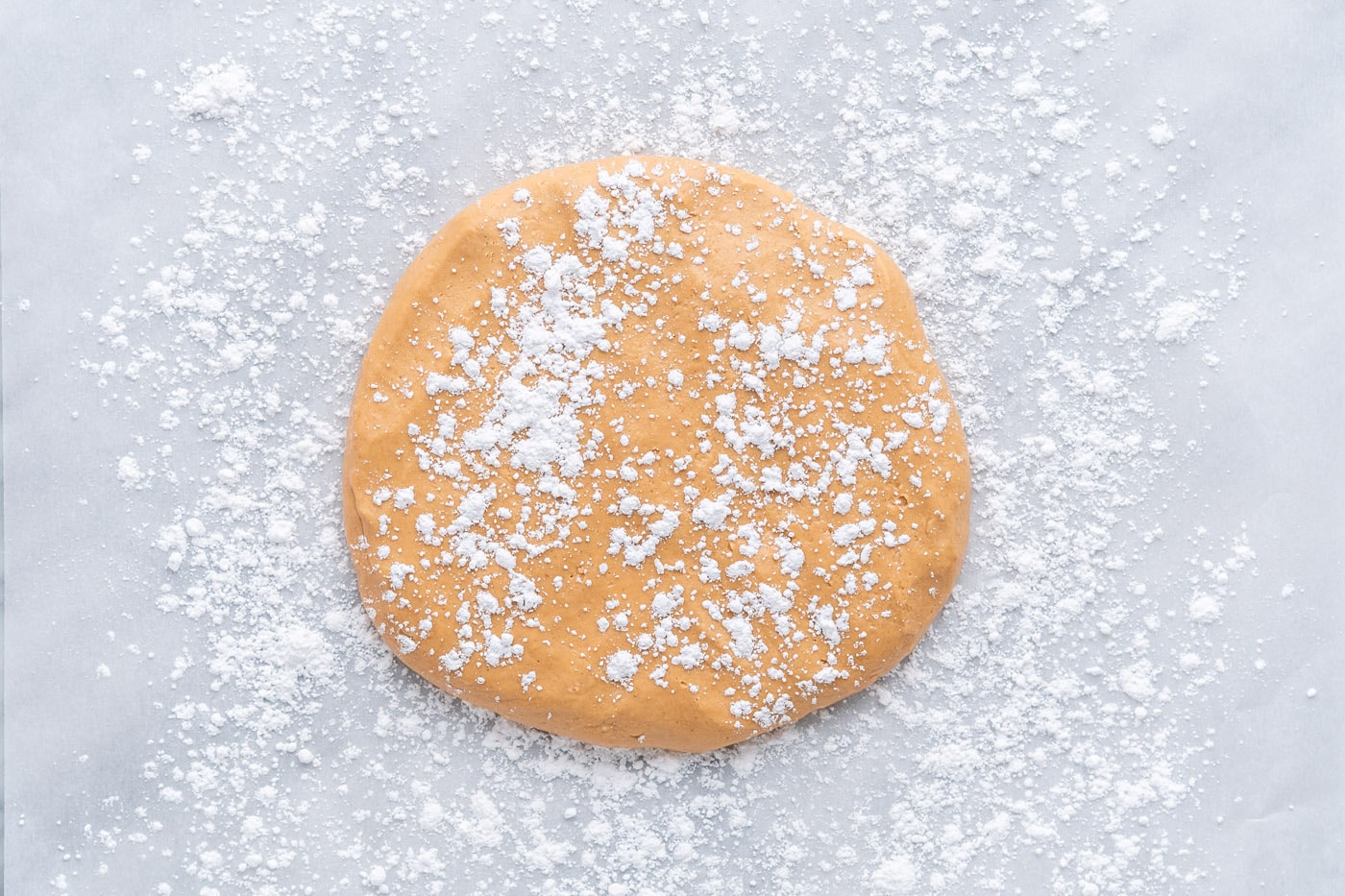 peanut butter dough laid flat with powdered sugar sprinkled on top