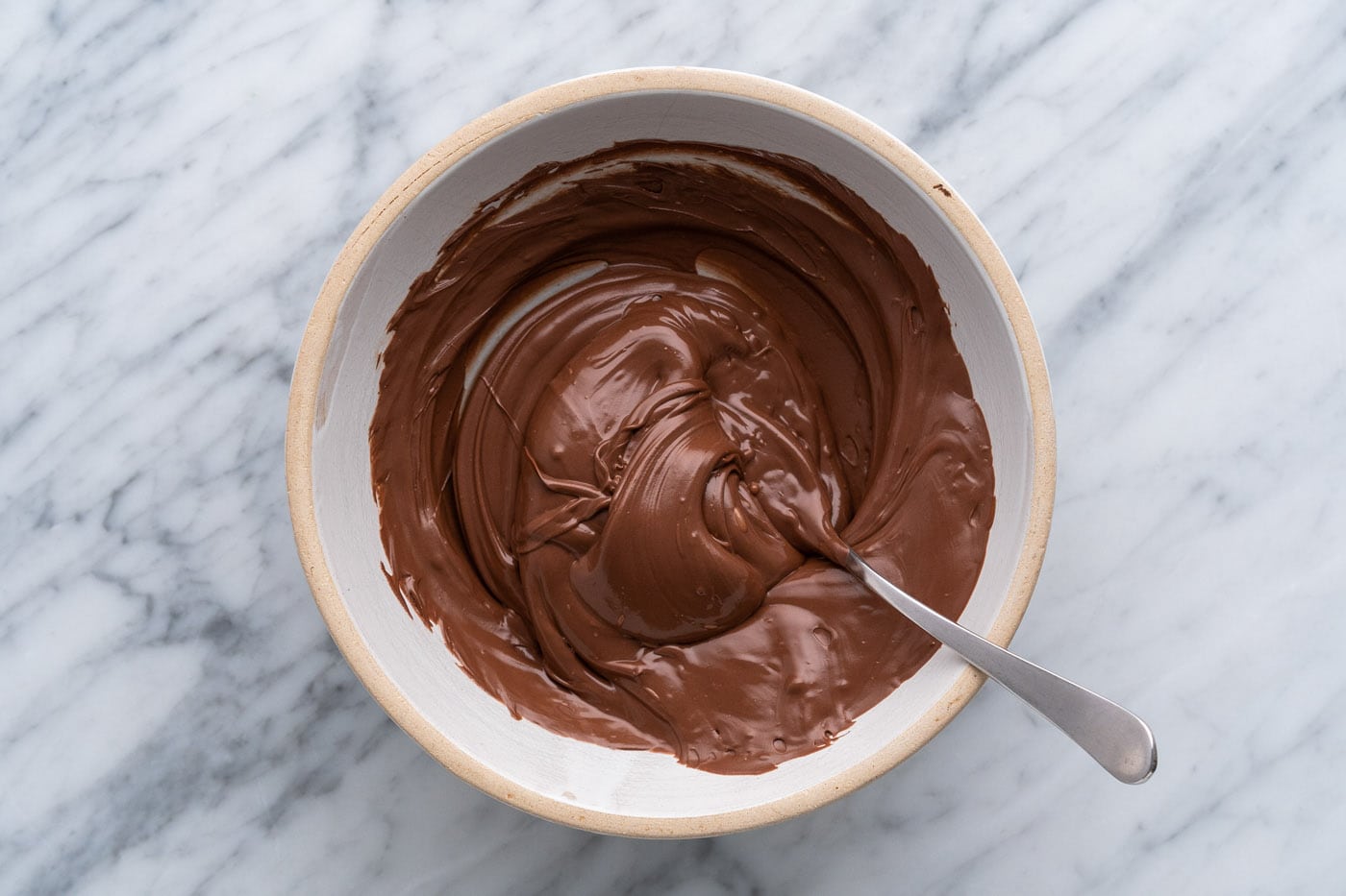 melted chocolate in a bowl with a spoon