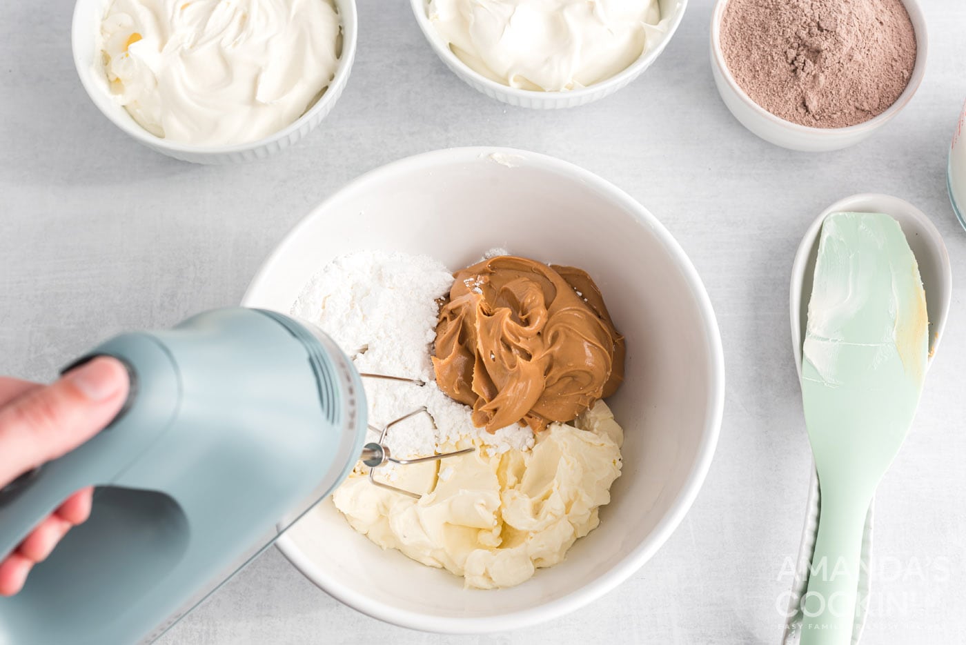 mixing peanut butter, powdered sugar and cream cheese in a bowl