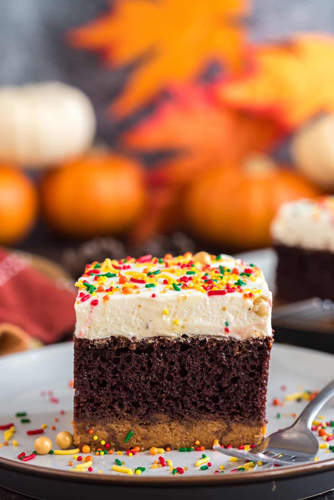 Square piece of Chocolate Pumpkin Magic Cake on a plate with a fork