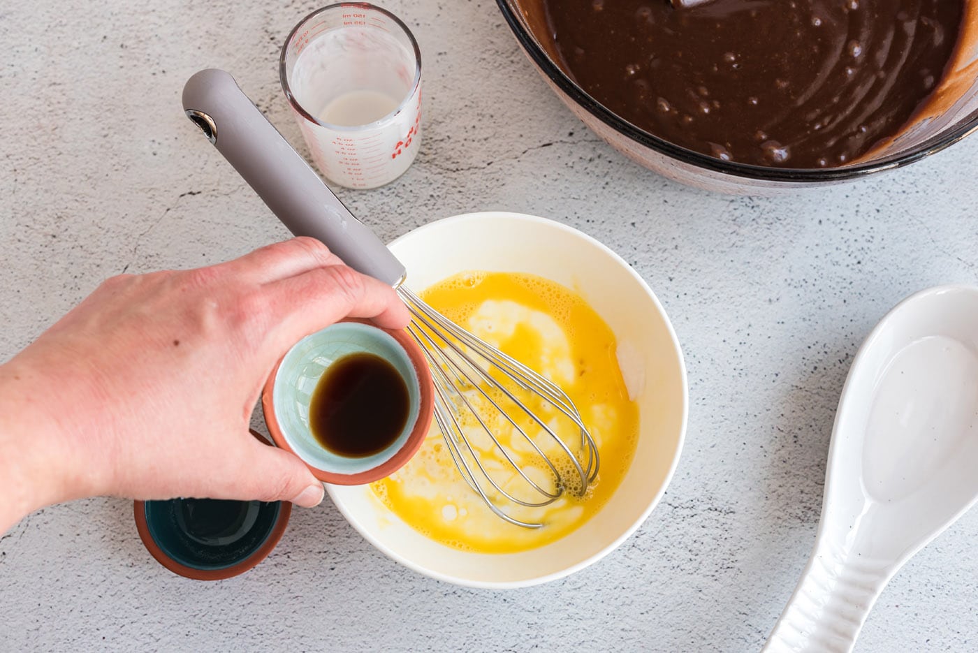 buttermilk, egg, baking soda, and vanilla in a bowl with a whisk