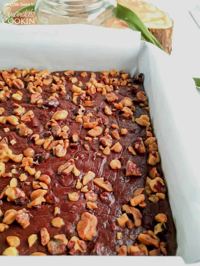 A a close up of a pan filled with chocolate walnut fudge.