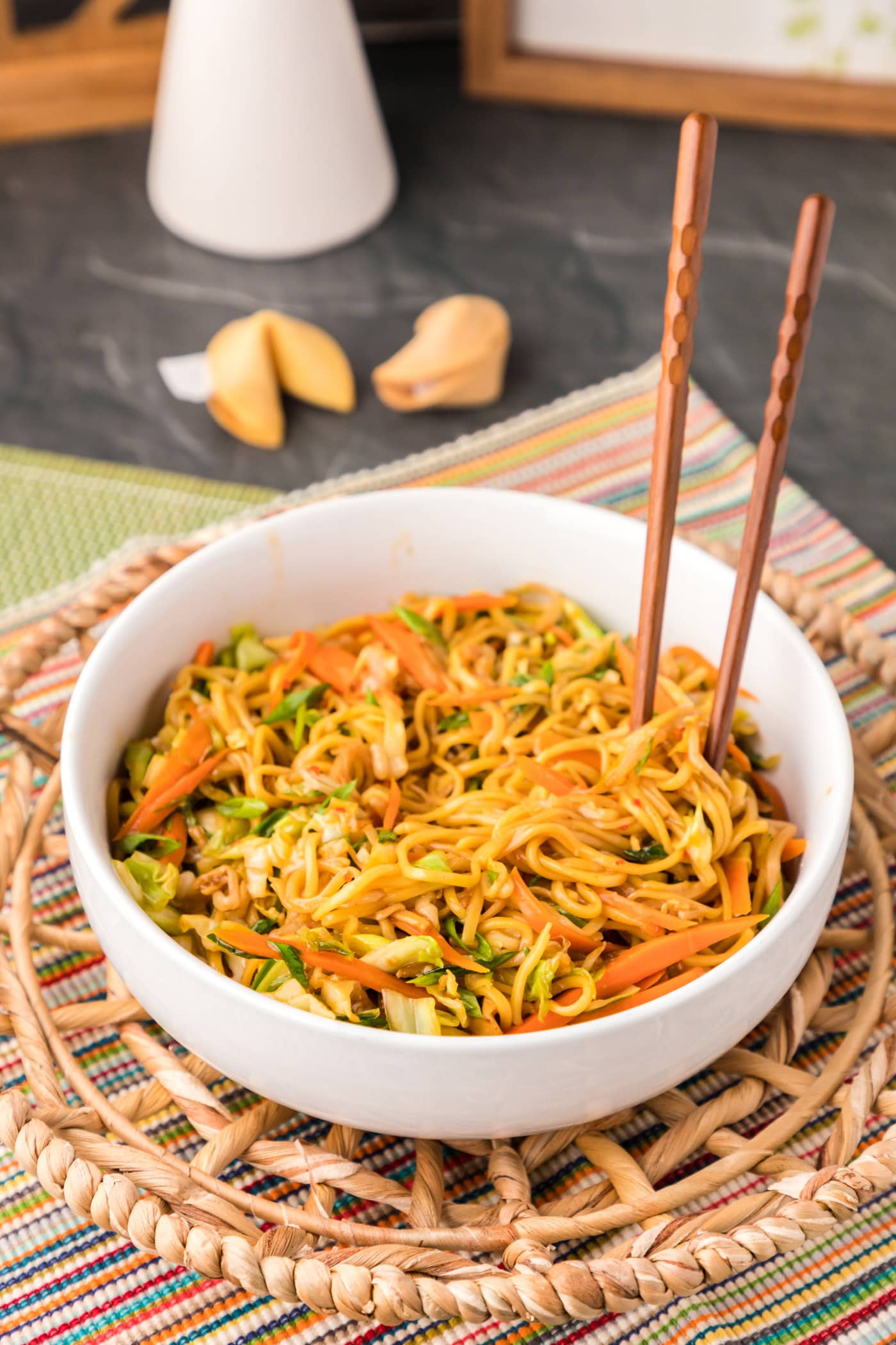 chopsticks standing in bowl of Chow Mein