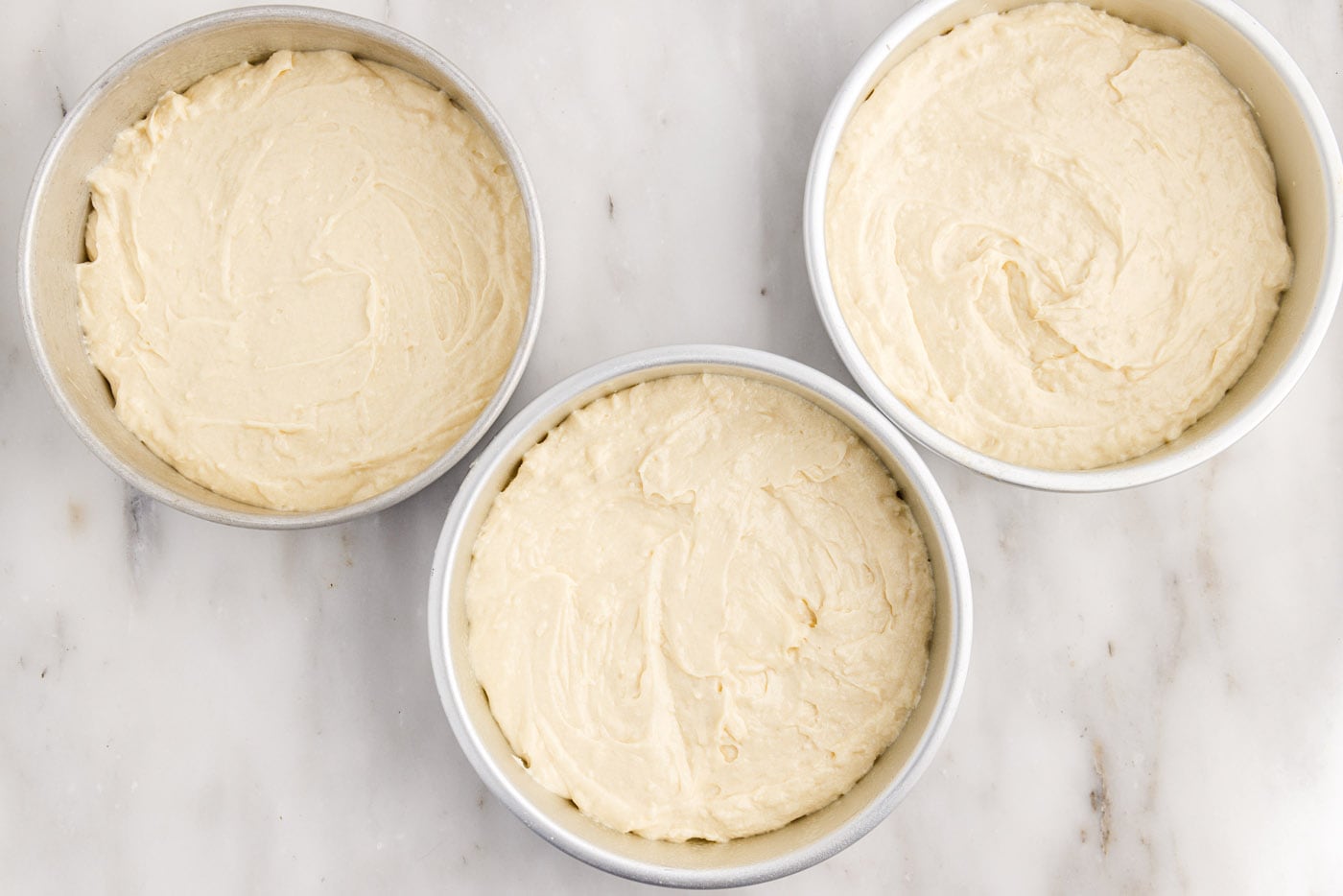 coconut cake batter in pans