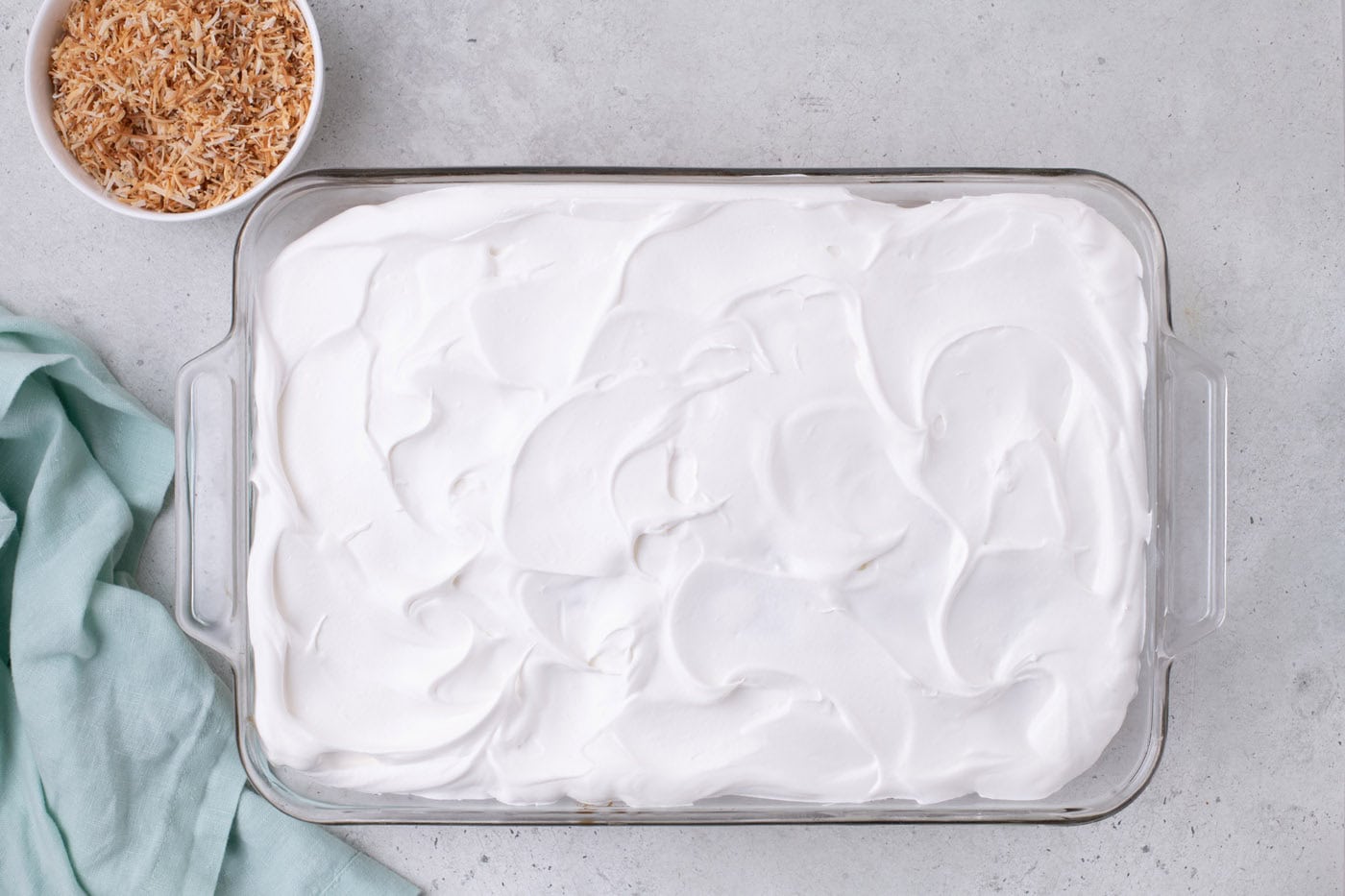 whipped topping spread over cake