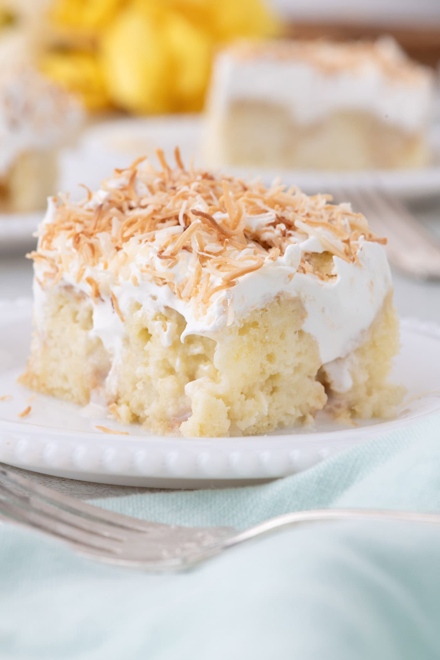 Slice of Coconut Poke Cake on a plate