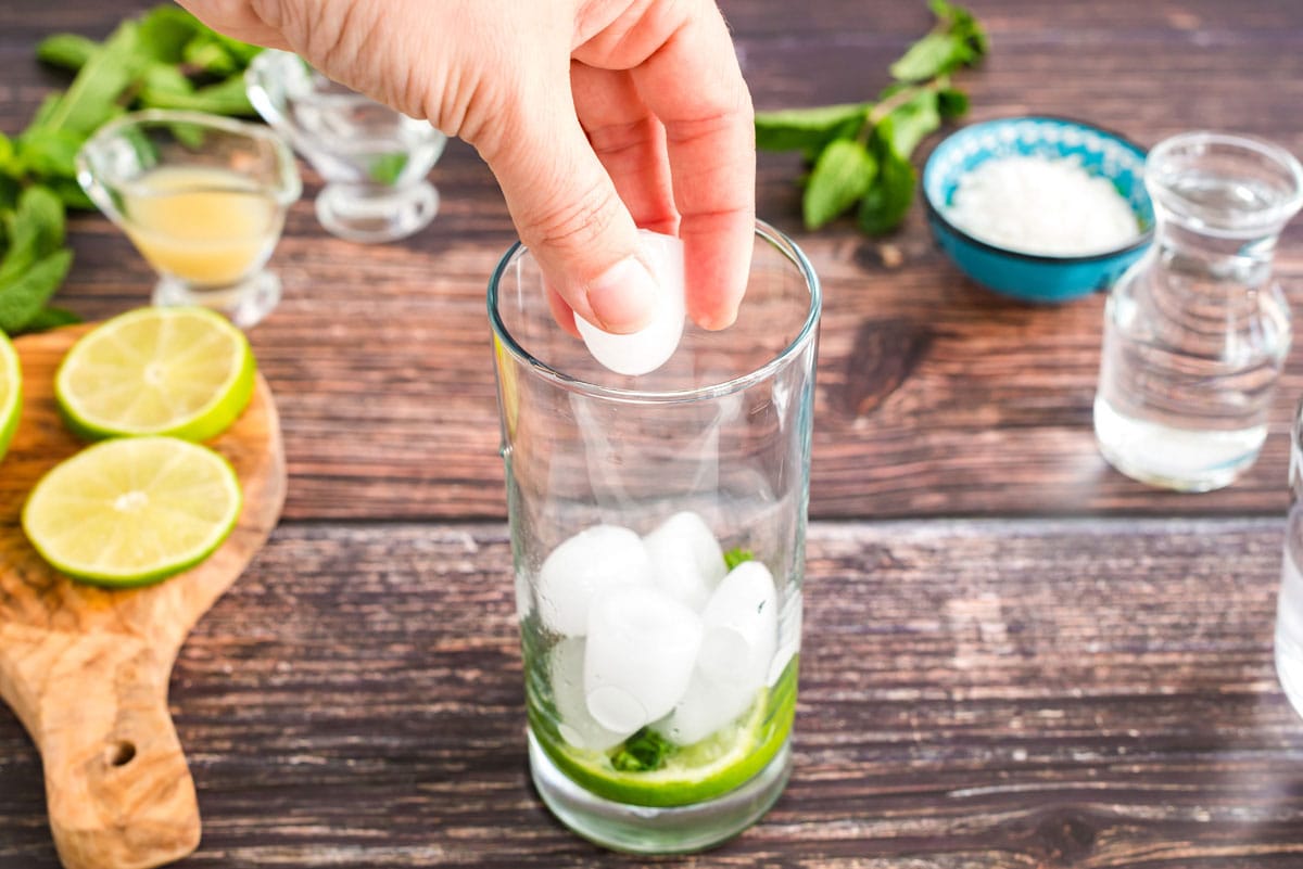 adding ice to glass