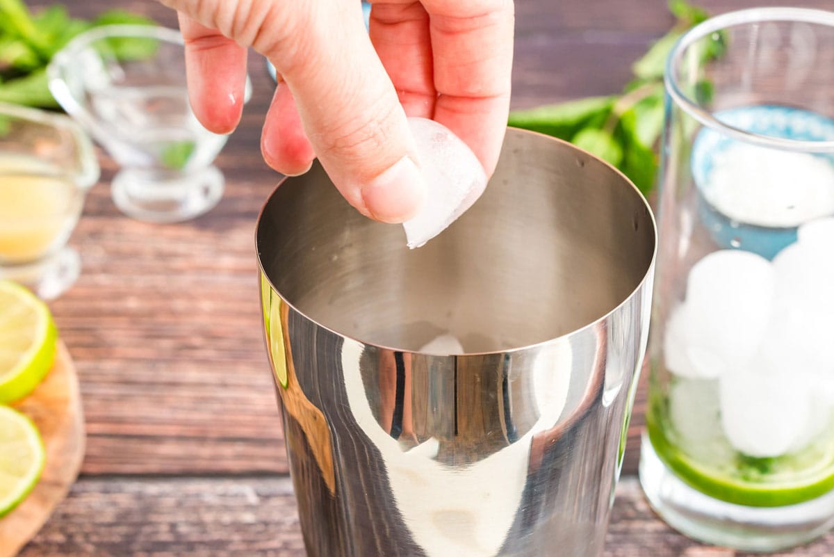 adding ice to cocktail shaker