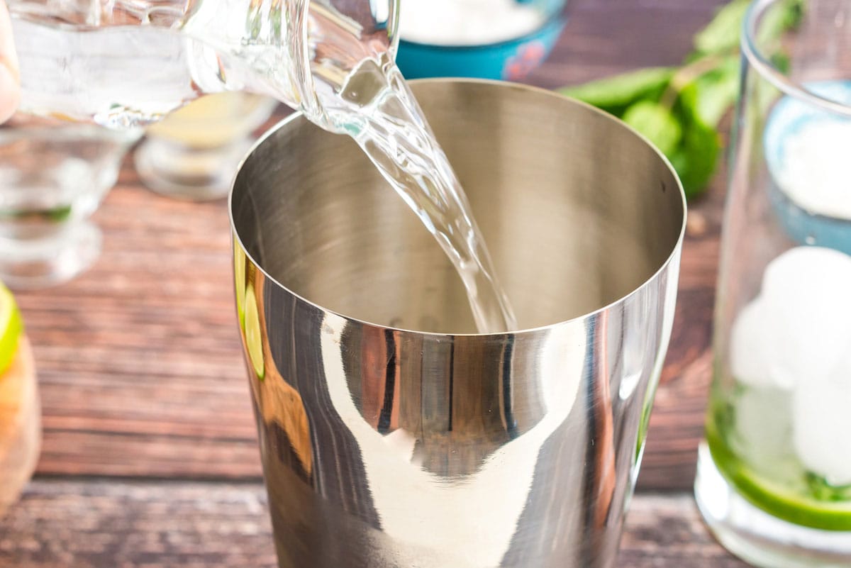 adding rum to cocktail shaker