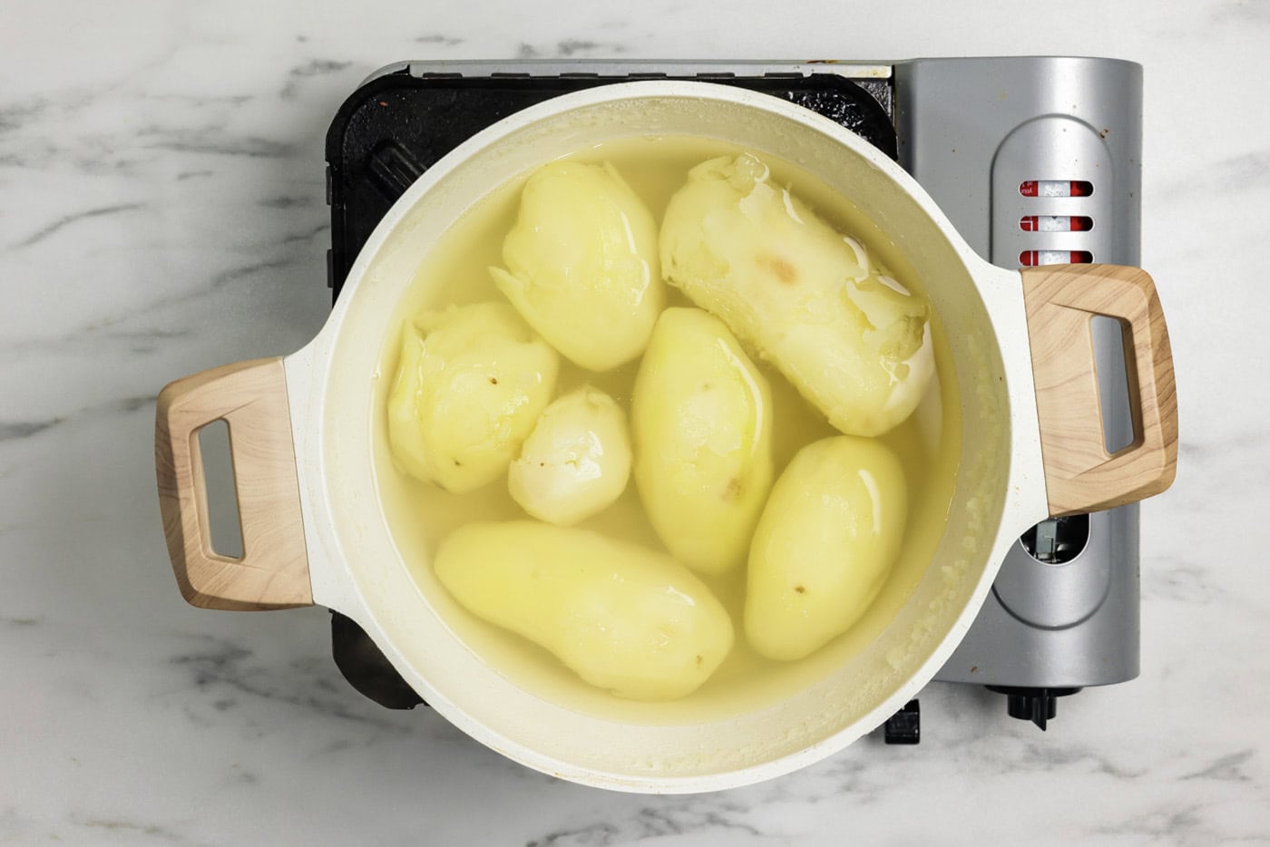 Peeled potatoes in a stockpot with water