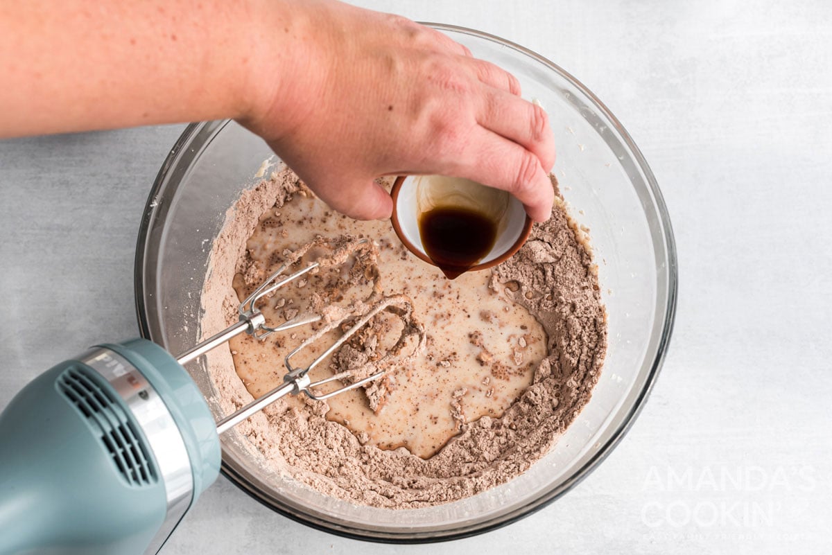 adding vanilla to the mixer bowl