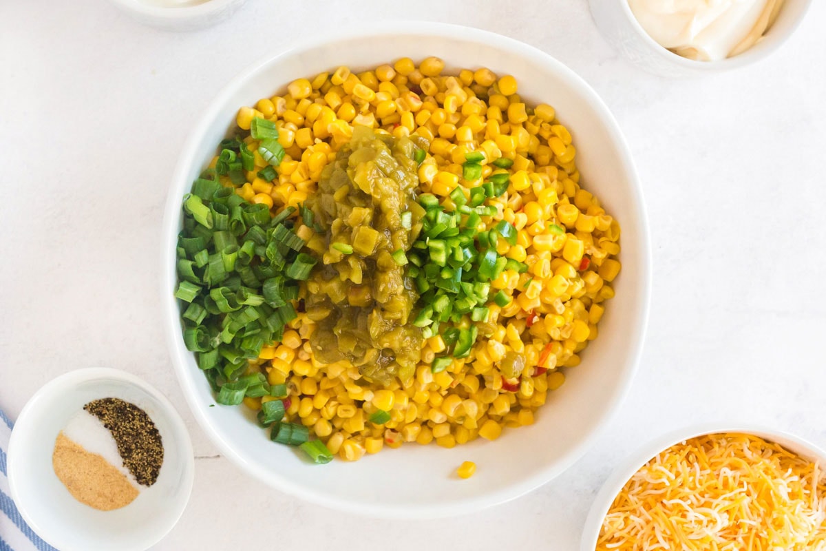 bowl of corn with green chiles, jalapeno, and green onion added