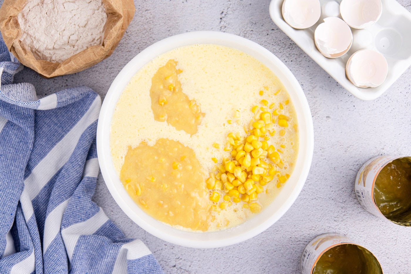 corn kernels and cream corn added to corn pudding batter