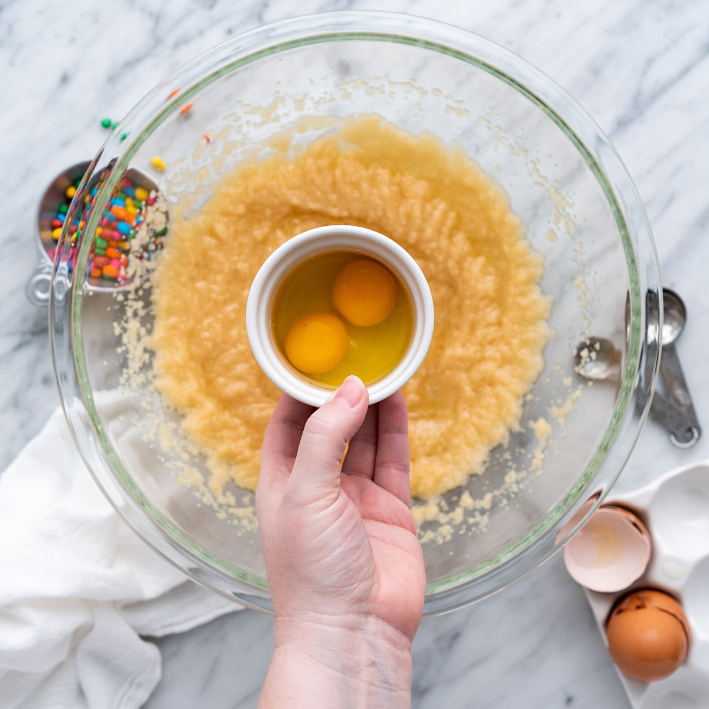 adding eggs to brownie wet batter