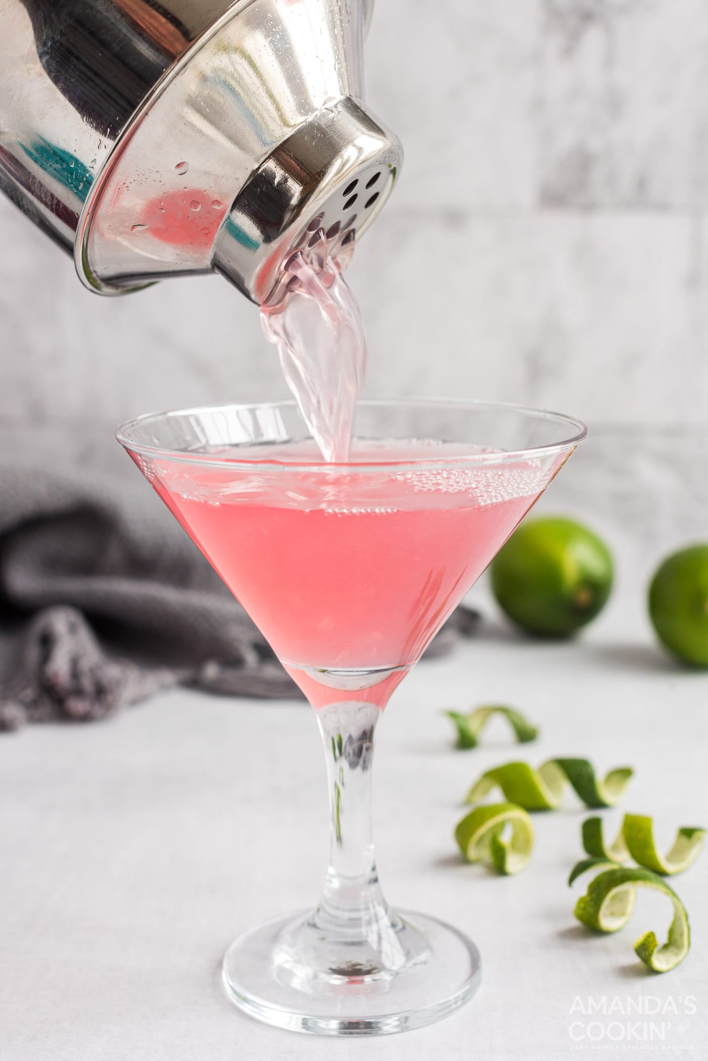 straining cosmo into glass