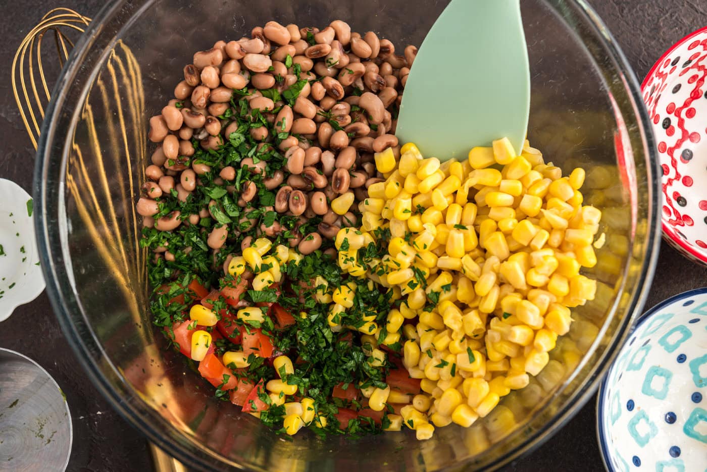 stirring cowboy caviar ingredients together in a bowl