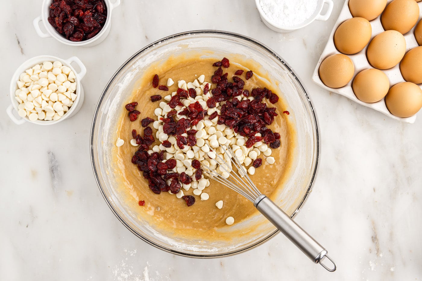 adding dried cranberries and white chocolate chips to blondie batter