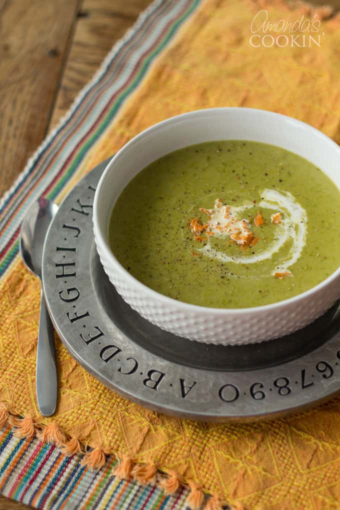 An overhead of a white bowl filled with cream of asparagus soup.