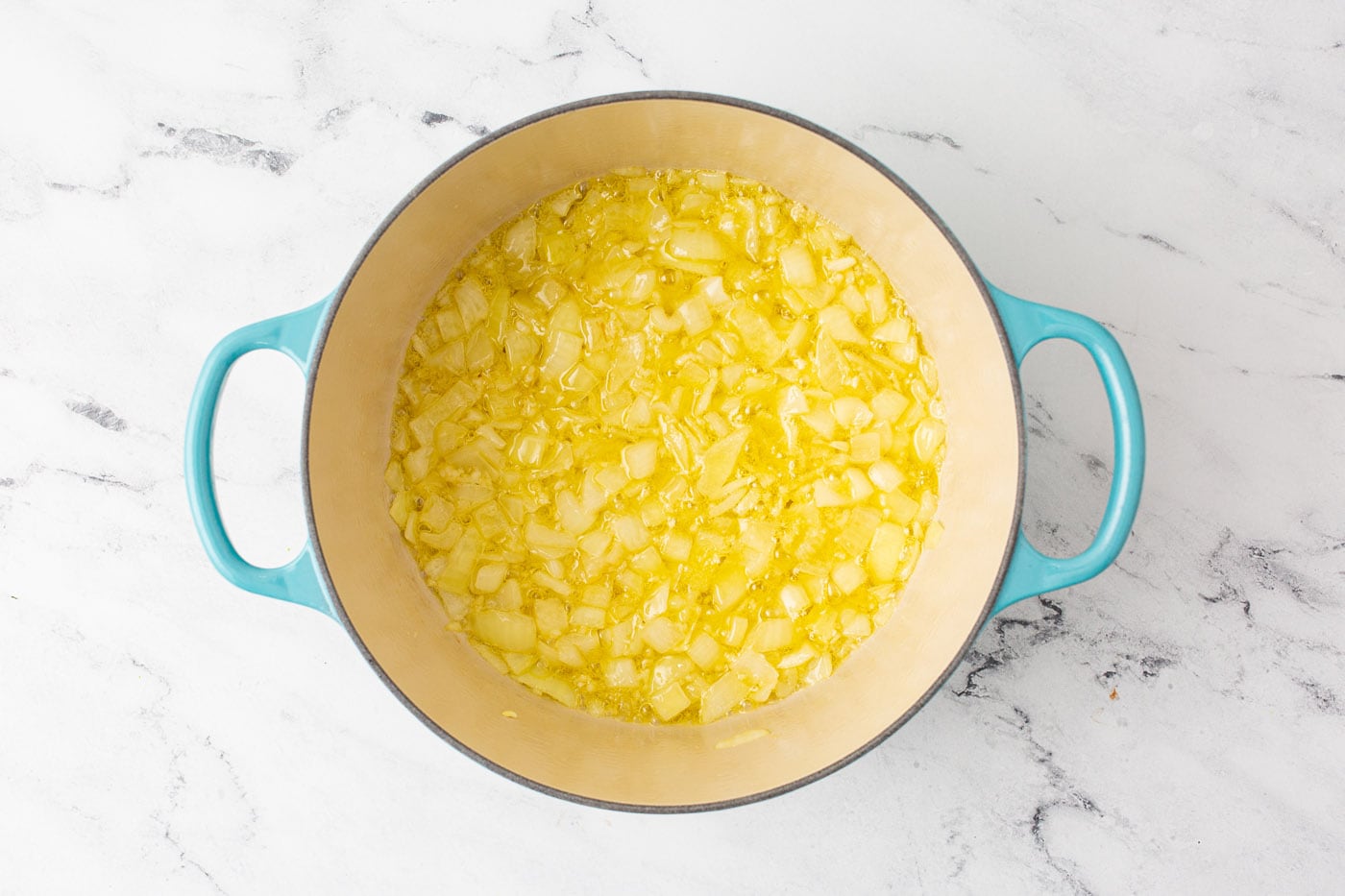 chopped onion with butter in a dutch oven
