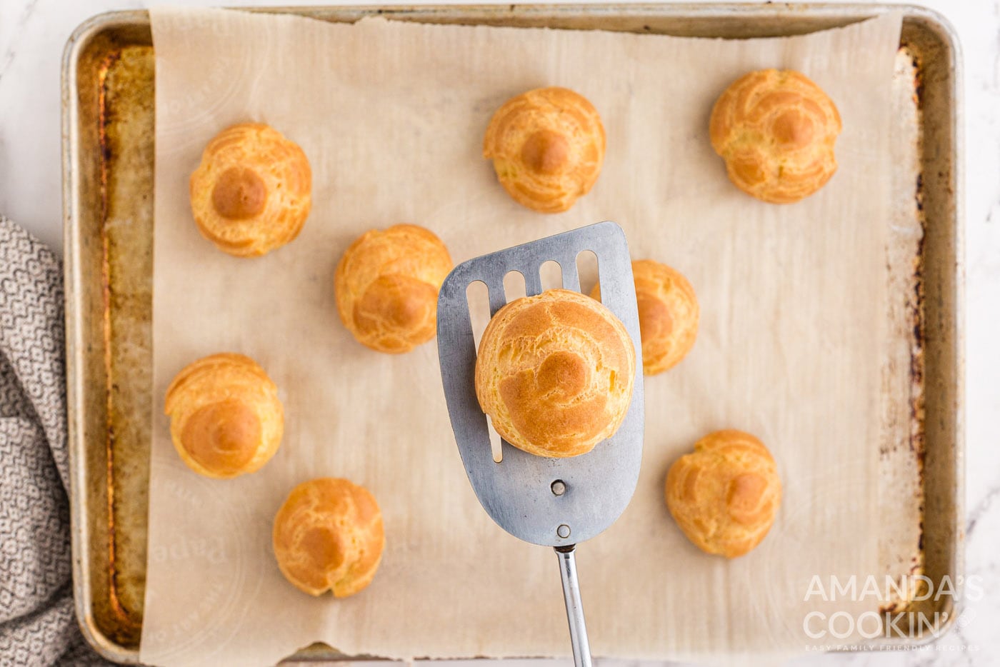 golden brown choux pastry on spatula