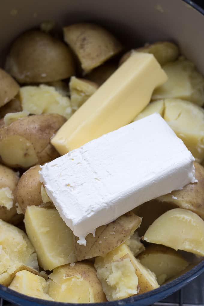 cream cheese and butter in cooked potatoes