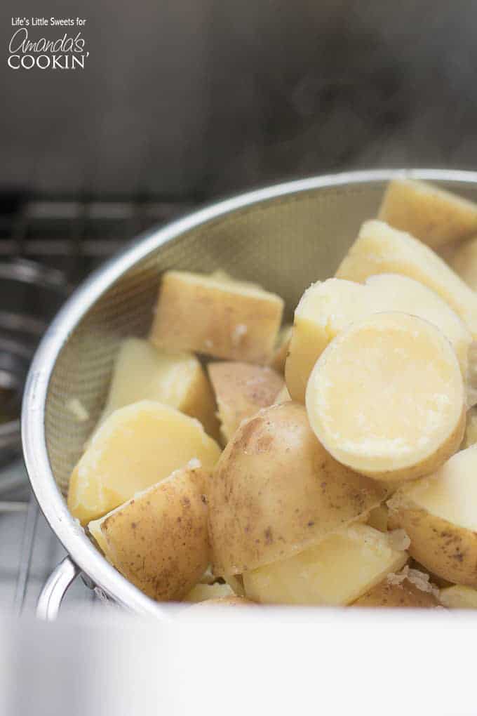 cut cooked potatoes in a colander