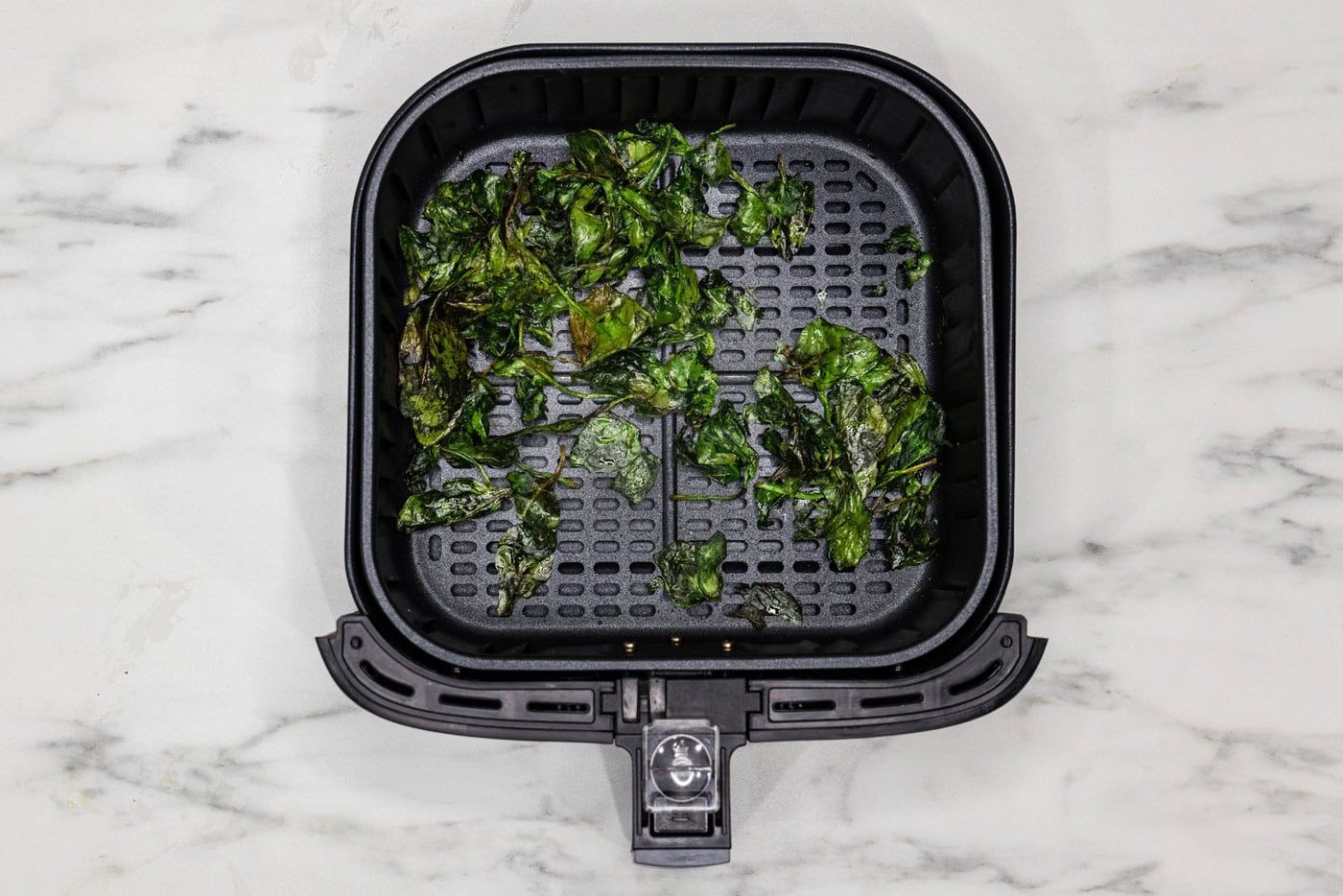 spinach chips in air fryer basket