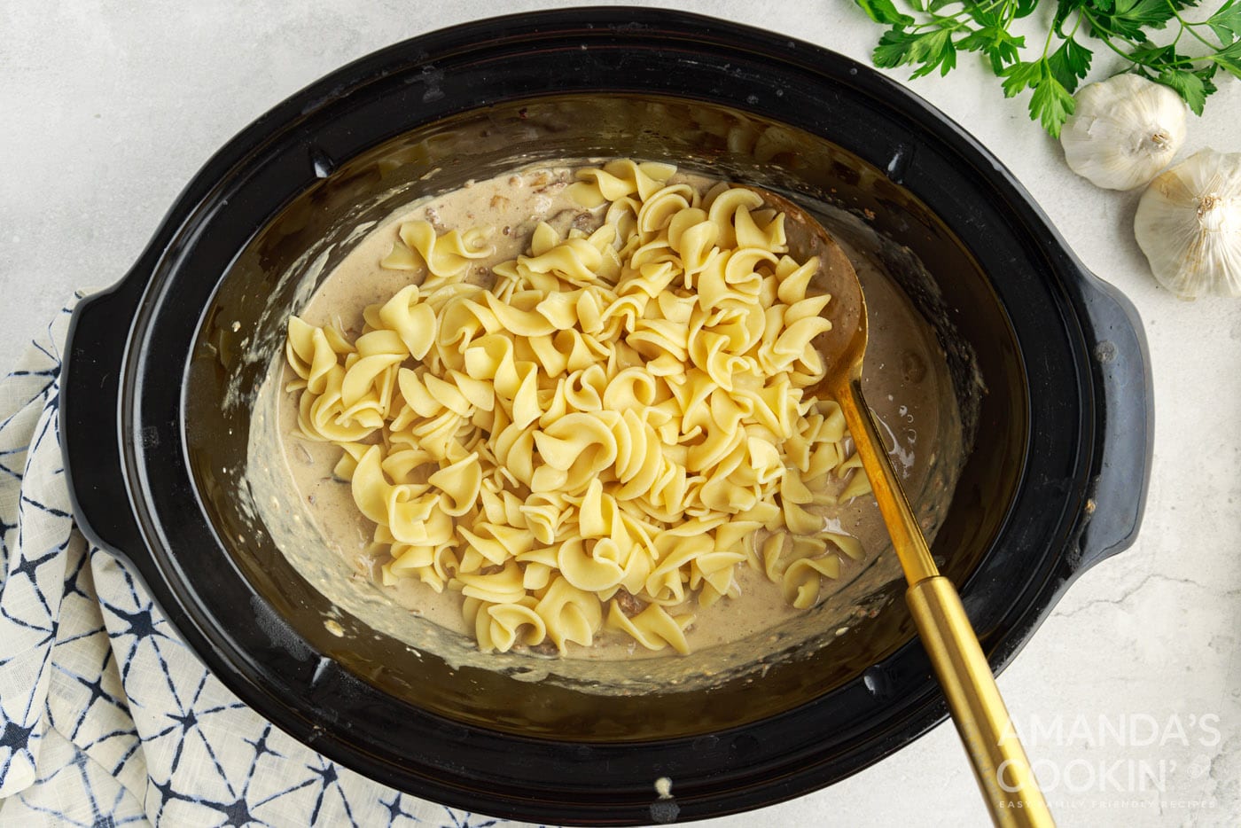 egg noodles mixed into beef stroganoff in the crockpot