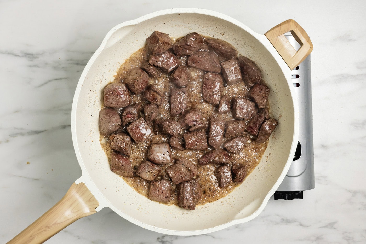 Sirloin cubes browned in a skillet
